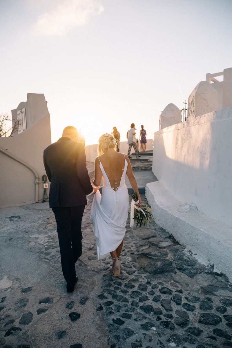 Santorini wedding couple walking at Oia