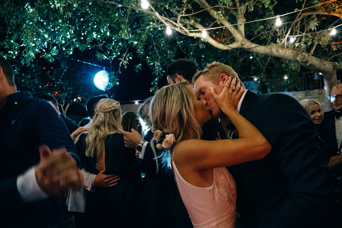 Bride and groom, kissing at wedding reception at Santorini